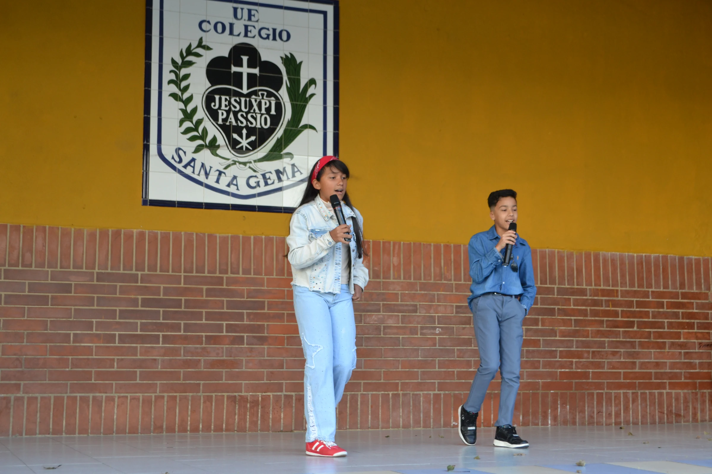 Estudiantes presentan una actividad de canto en el escenario